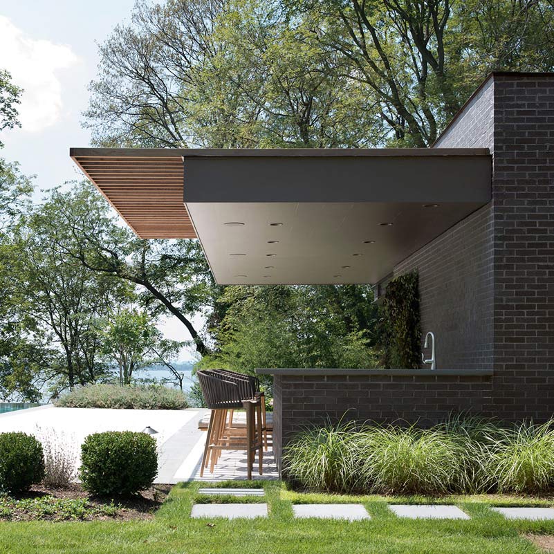black brick modern cantilevered pool cabana by john patrick winberry