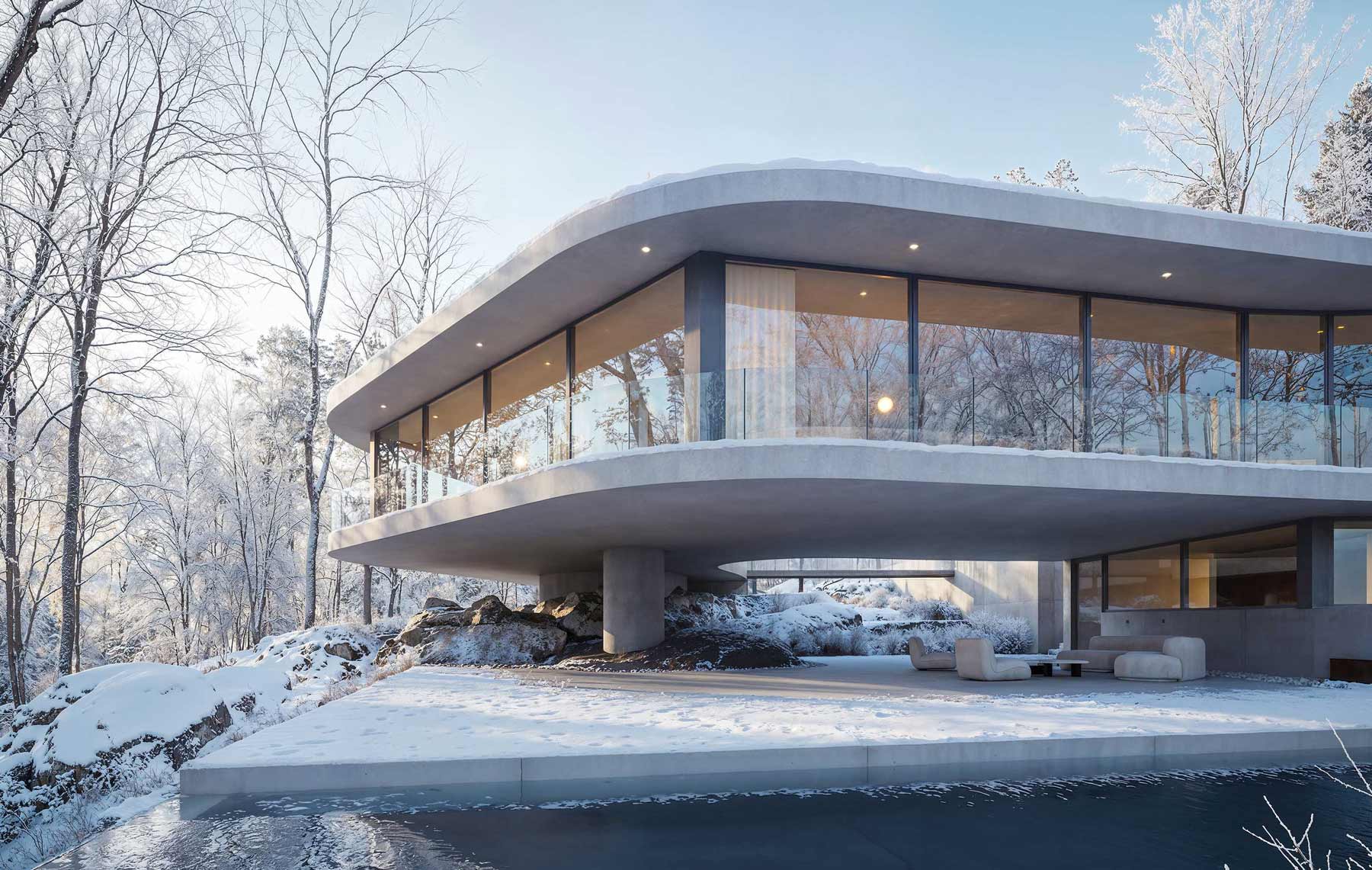 luxury modern home in the woods with custom concrete infinity pool in snow
