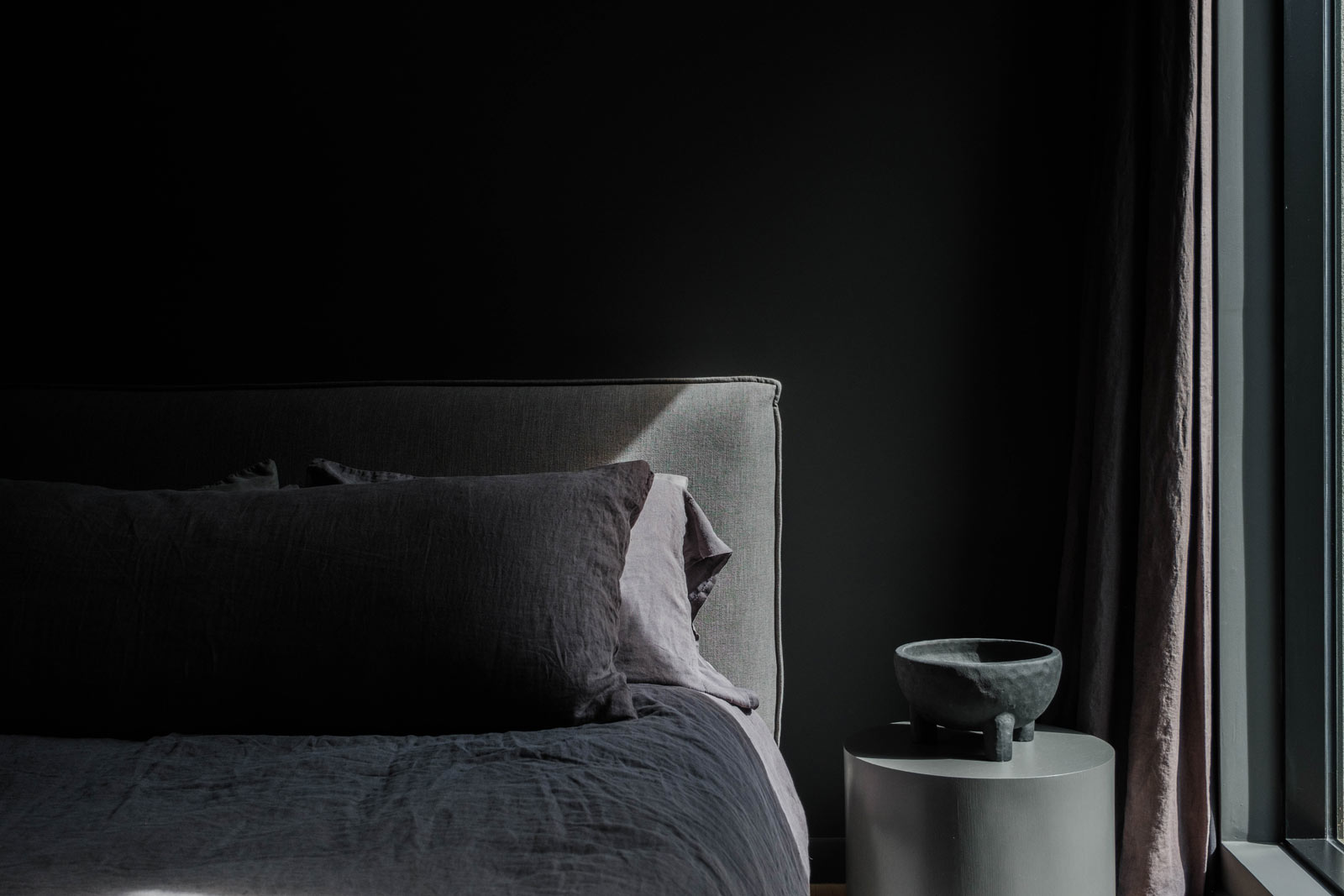 dark modern bedroom in scandi long island home design