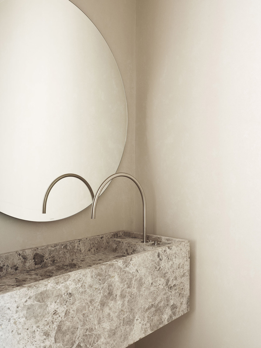 limestone vanity and minimal modern fixtures in microcement bathroom interiors