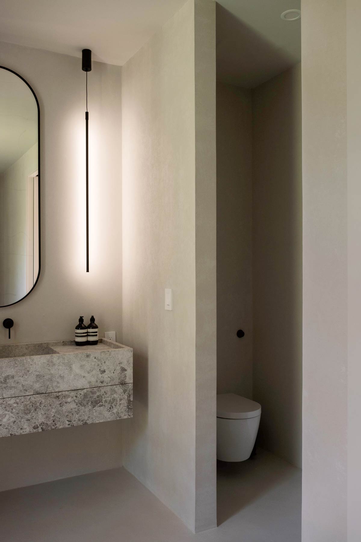 micro-cement plastered minimal primary bathroom interior design