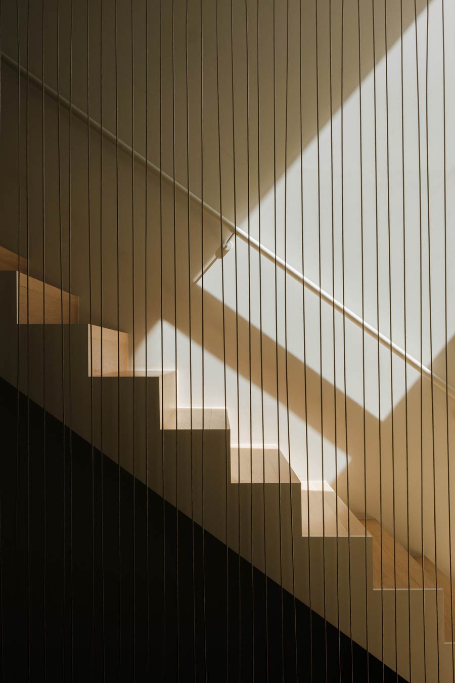 sleek minimal wire rail detail in residential interior stair