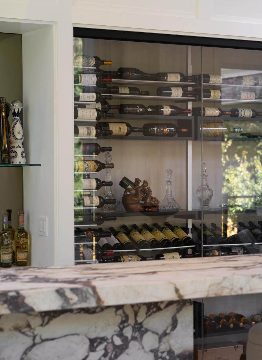 glass wine room with custom millwork in modern home design