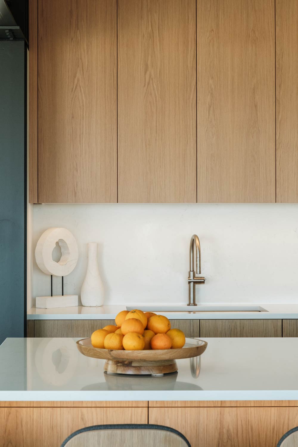 minimal organic wood panel-ready kitchen cabinets in modern beach home