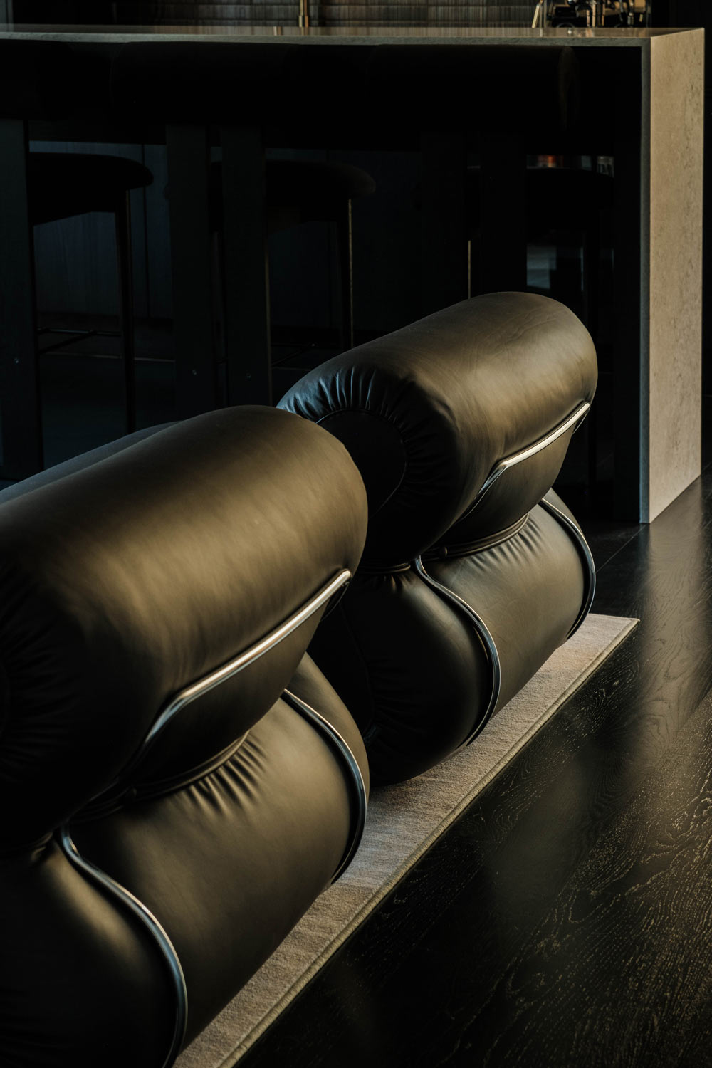 comfy low black modern chairs in home bar interior design