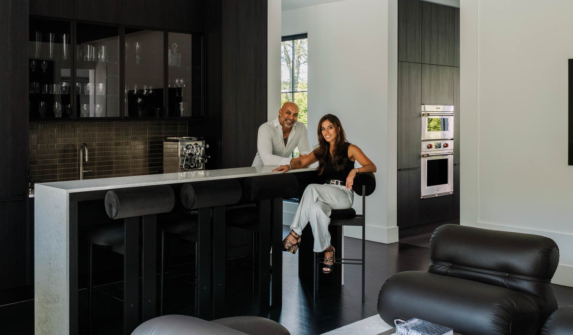 couple in modern black wood home bar interior design