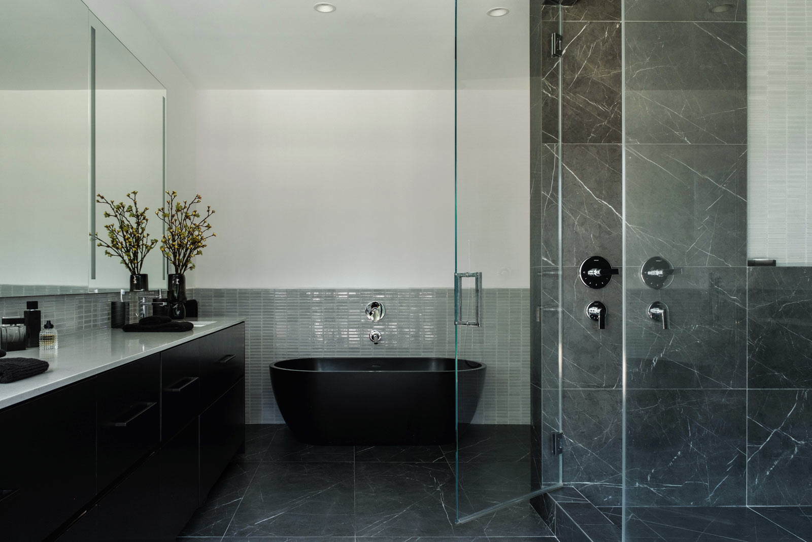 large dark modern primary bathroom with black floating tub and walkin shower