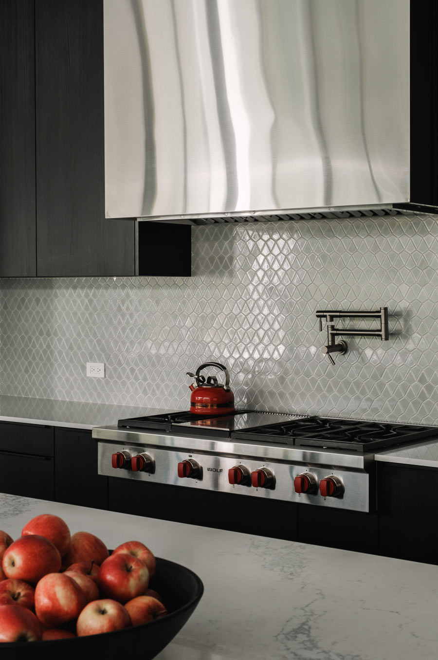 minimal black and stainless steel kitchen with pot filler