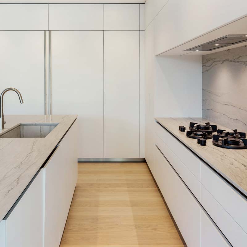 A minimal integrated stovetop design in a home by The Up Studio.
