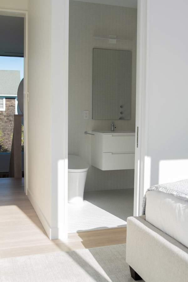 Sleek all-white modern bathroom en suite interior