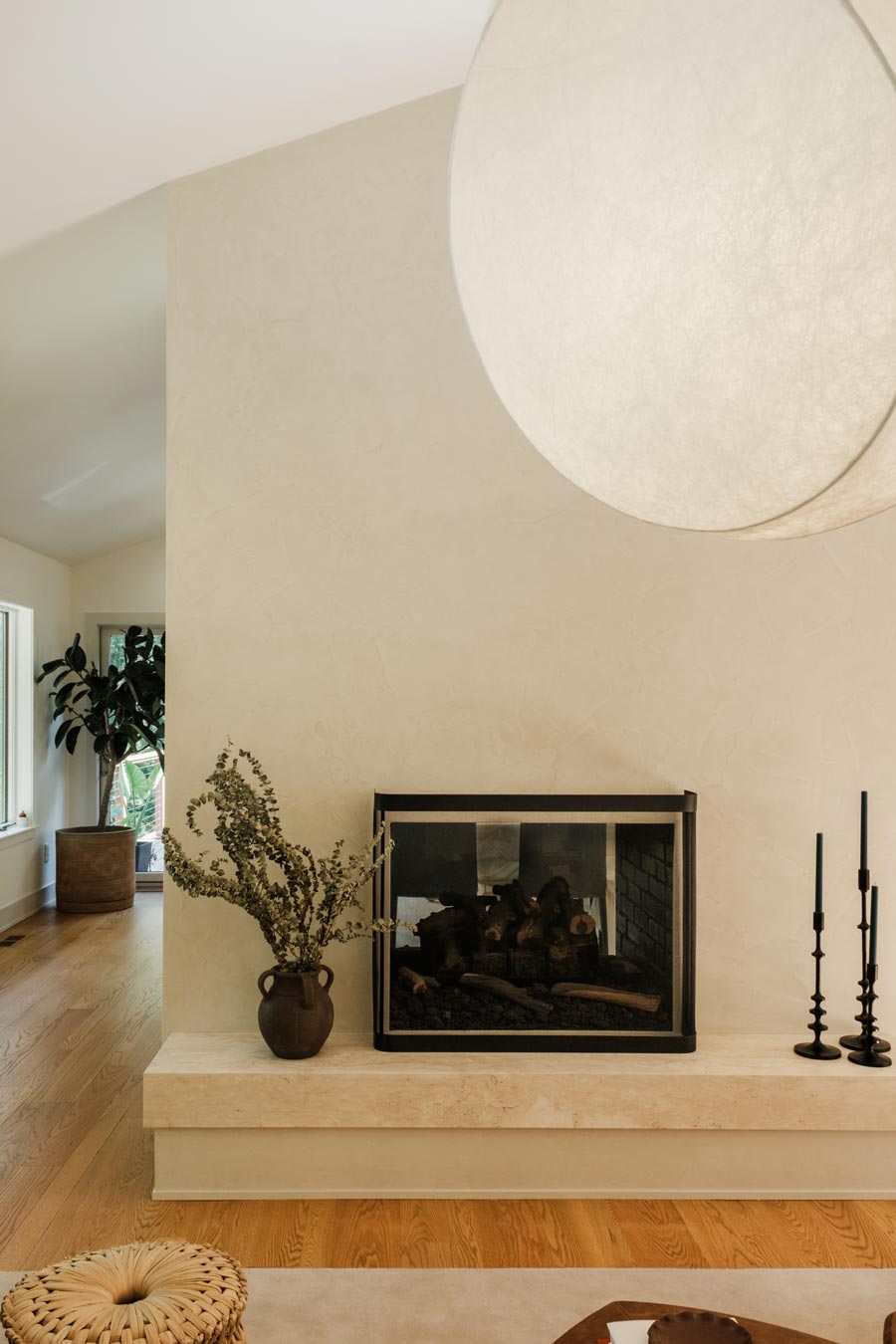 hand-troweled plaster fireplace in soft modern living room interior