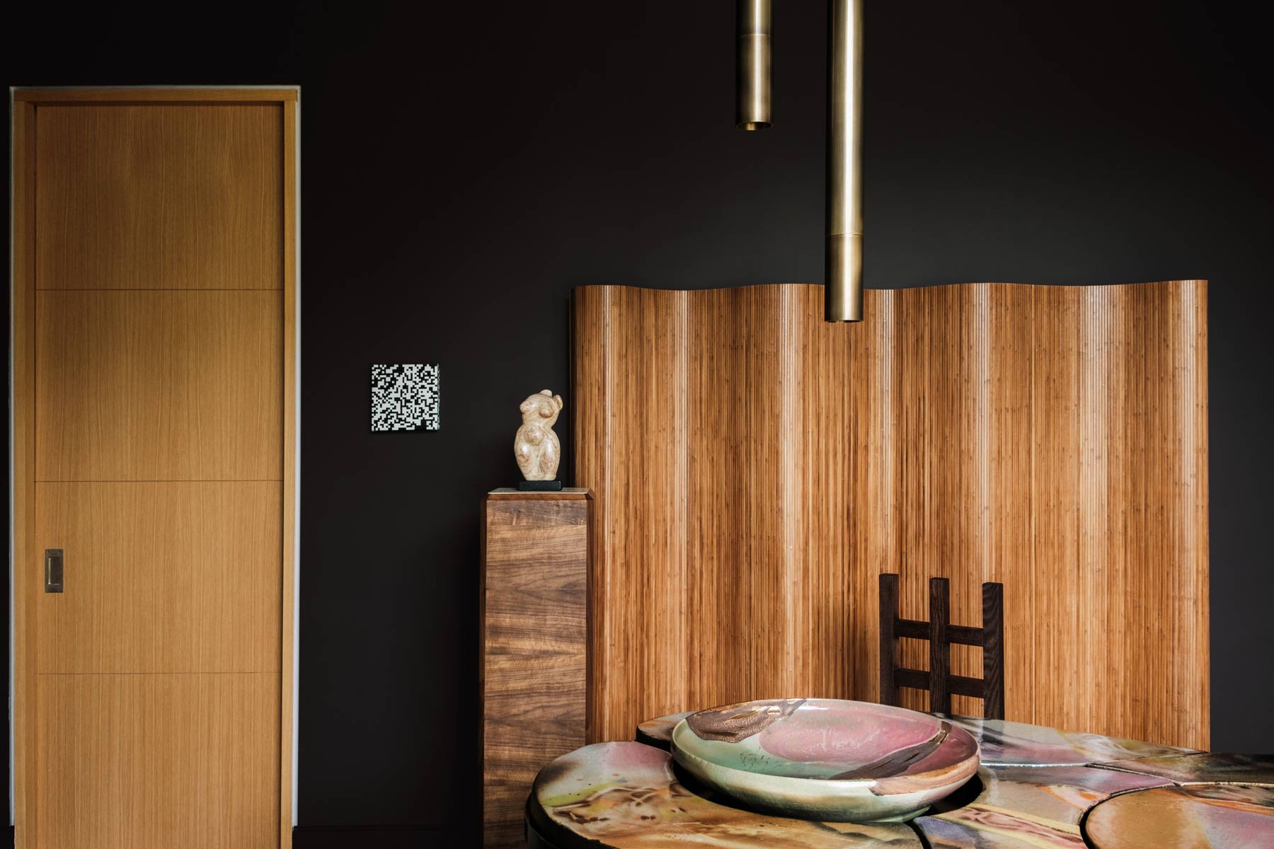curving wood screen on dark wall in modern office interior design