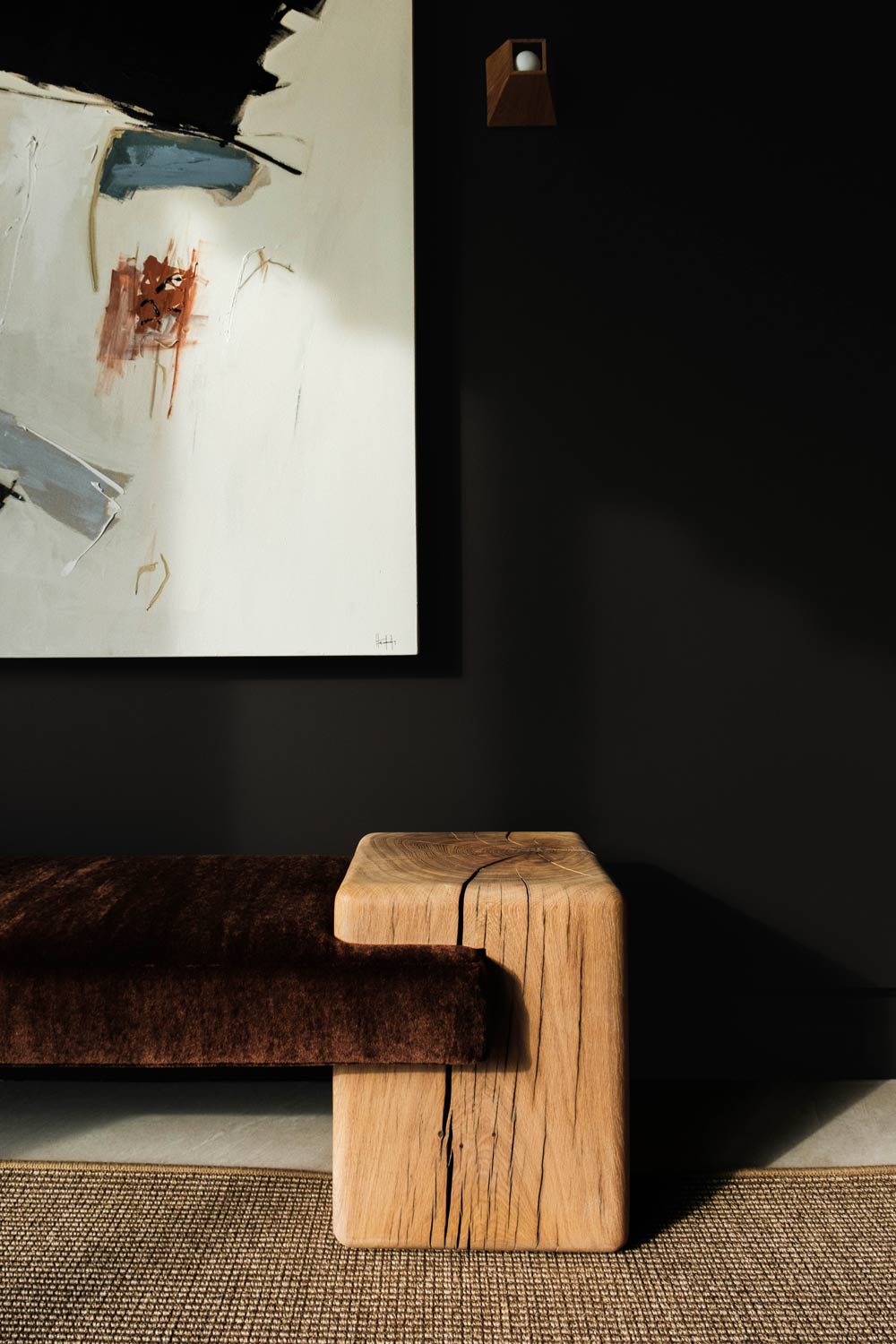 custom wooden bench and minimal painting in dark hamptons interior design