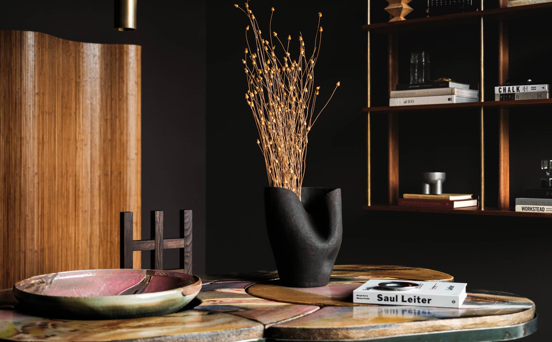 dark modern office interior design with colorful ceramic desk and wood screen and shelf