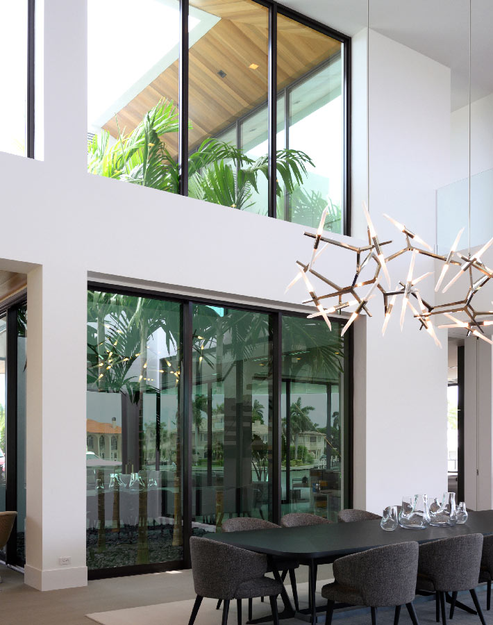modern dining room interiors and planted tropical atrium in florida residence
