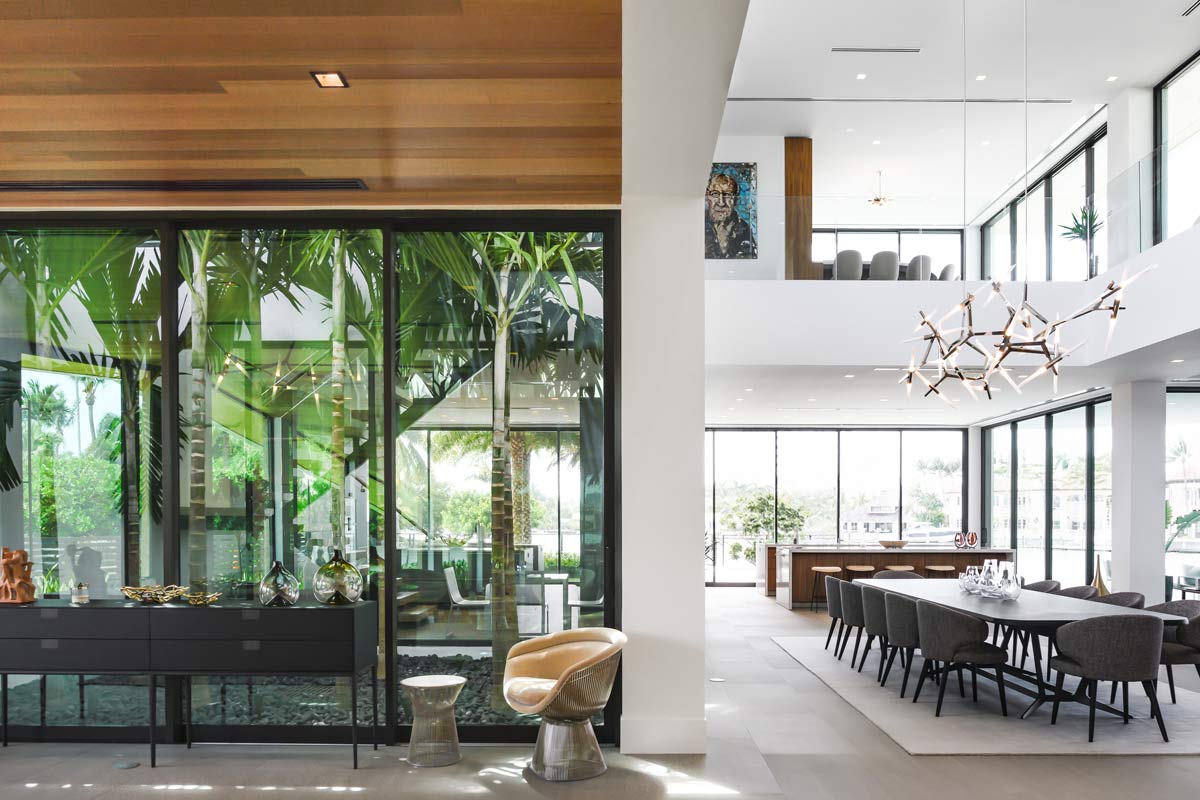 open floor plan modern interiors with tropical planted atrium and modern furnishings