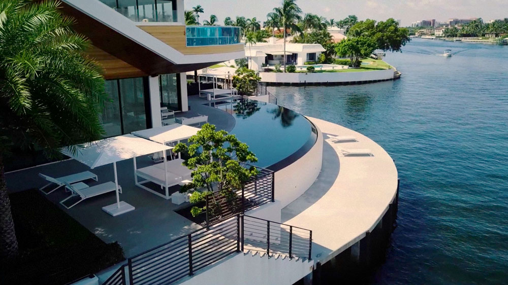 tropical modern architecture second story pool and rounded waterfall edge pool