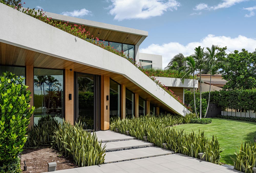 tropical modern home architecture with sloping planted green roof