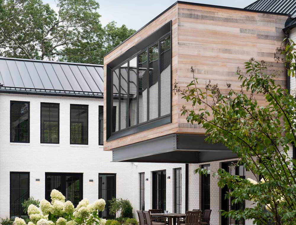 Home Design for Modern Farmhouse Residence with white brick and black window frames and a cantilevered cedar master bedroom on Long Island, NY