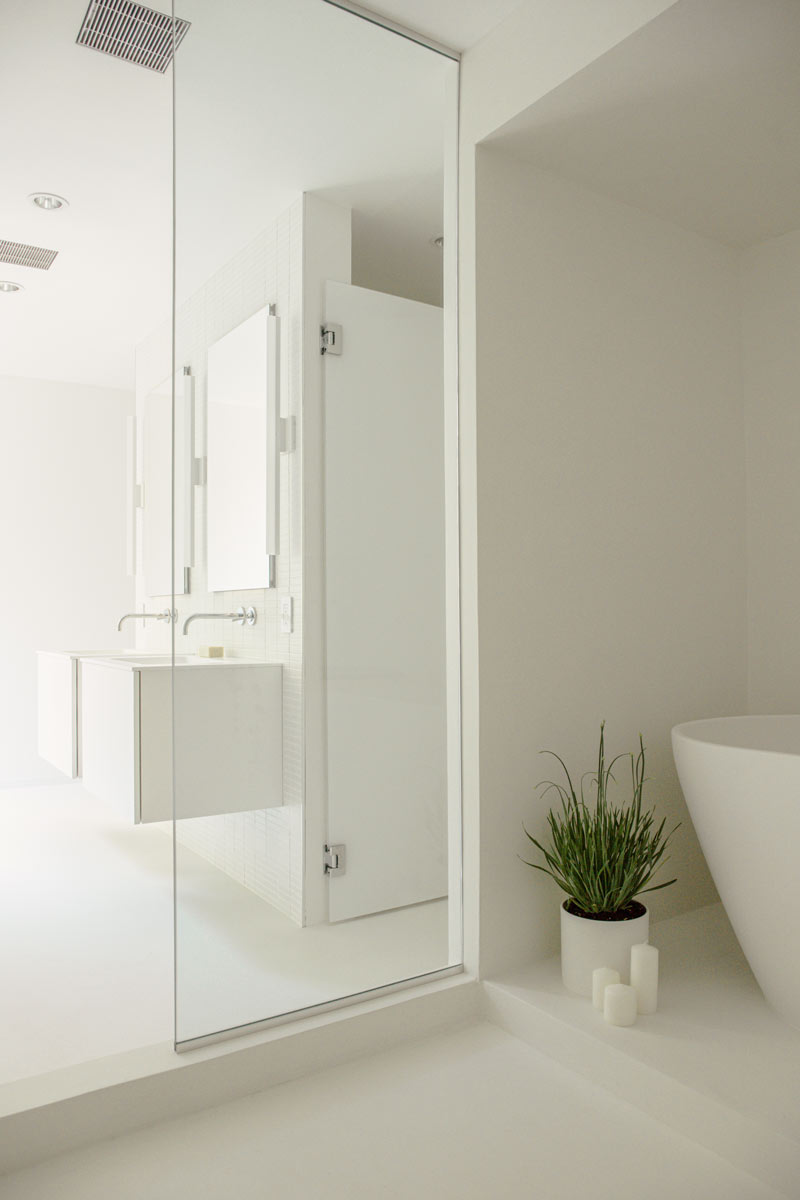 minimal bathroom with all-white microcement interiors