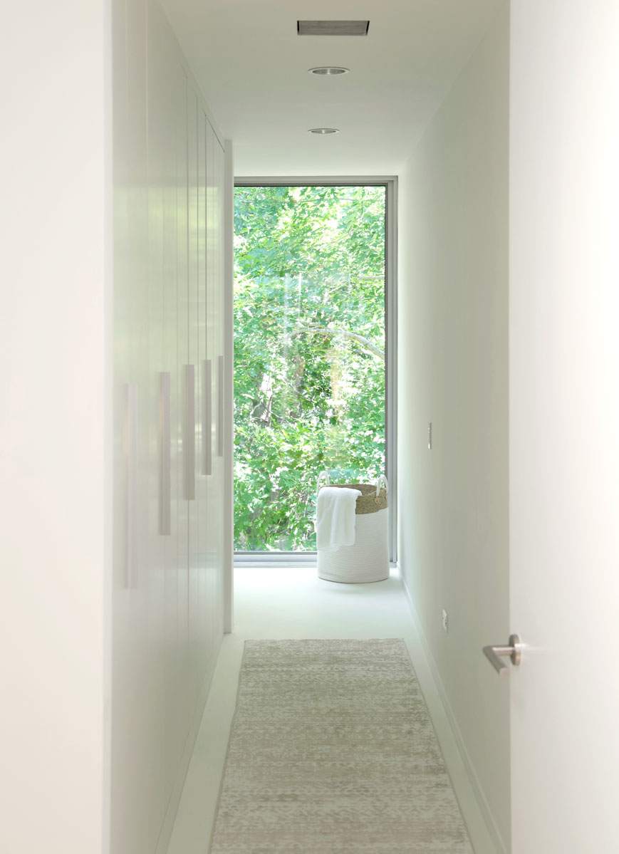 minimal home interior with white integrated storage enhancing nature views