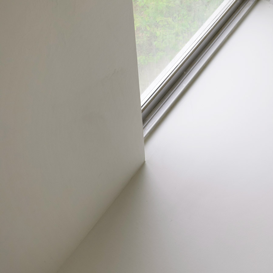 minimal white microcement bathroom interior window trim detail