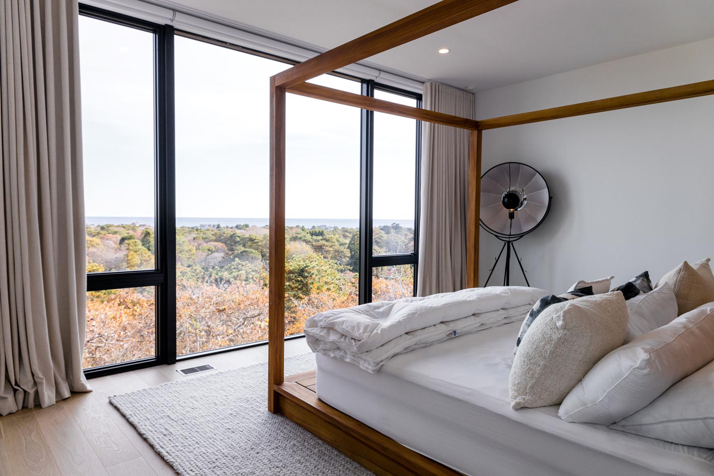 automatic window shades in a modern beach house by The Up Studio.