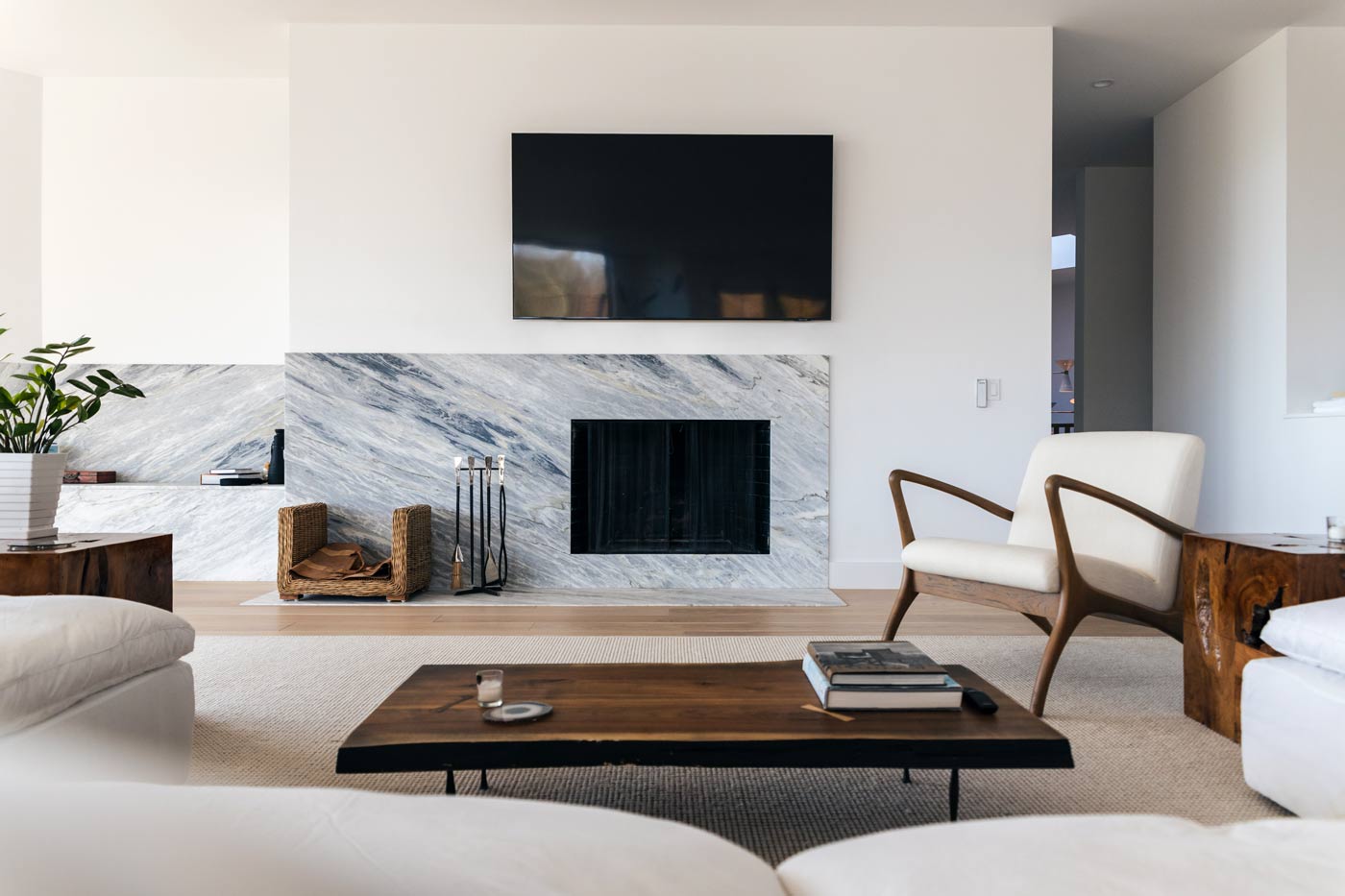 bright modern living room with custom marble fireplace and bench